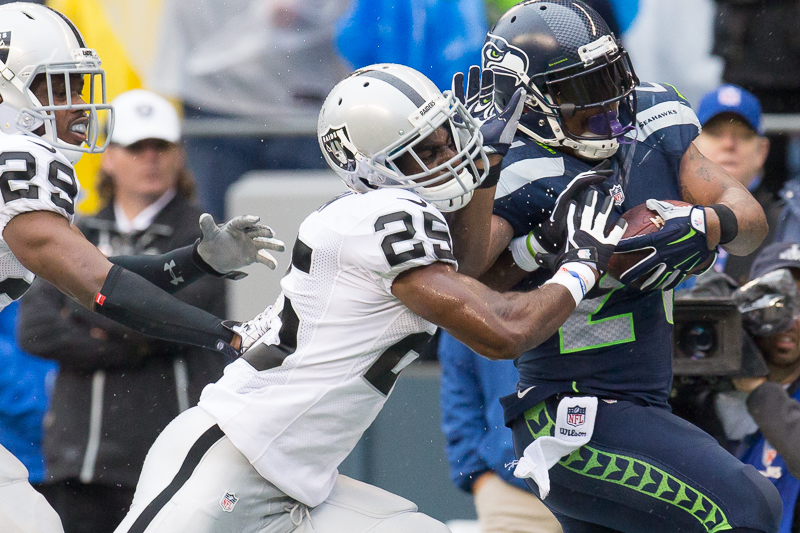 Marshawn Lynch fights off Raiders cornerback DJ Hayden on a 43-yard gain that was called back due to a penalty in the second quarter.