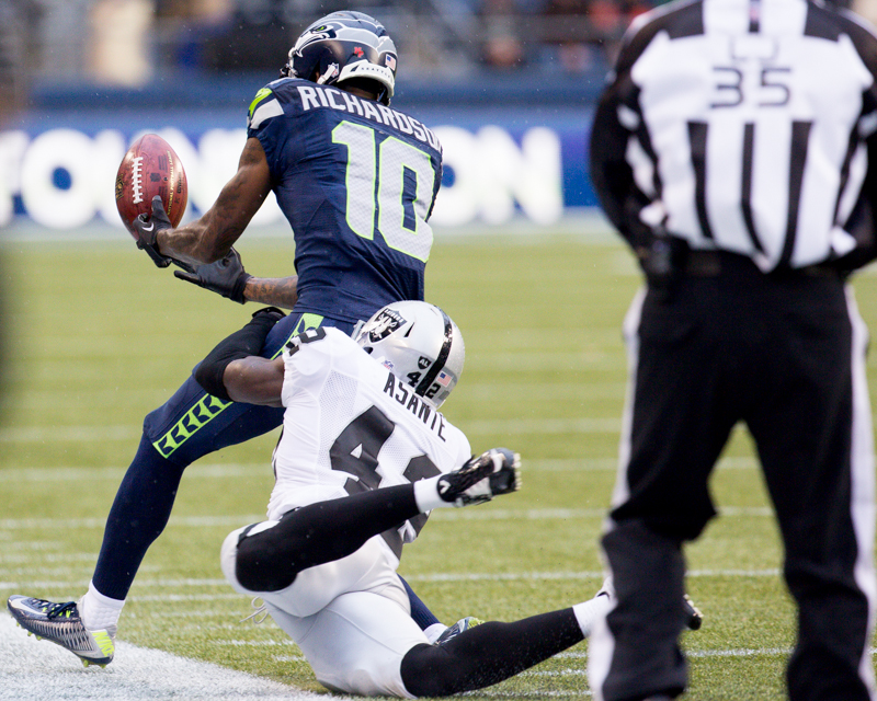 Seahawk's receiver Paul Richardson is dragged out of bounds by a Raiders defender after a 36 yard punt return to start the third quarter.