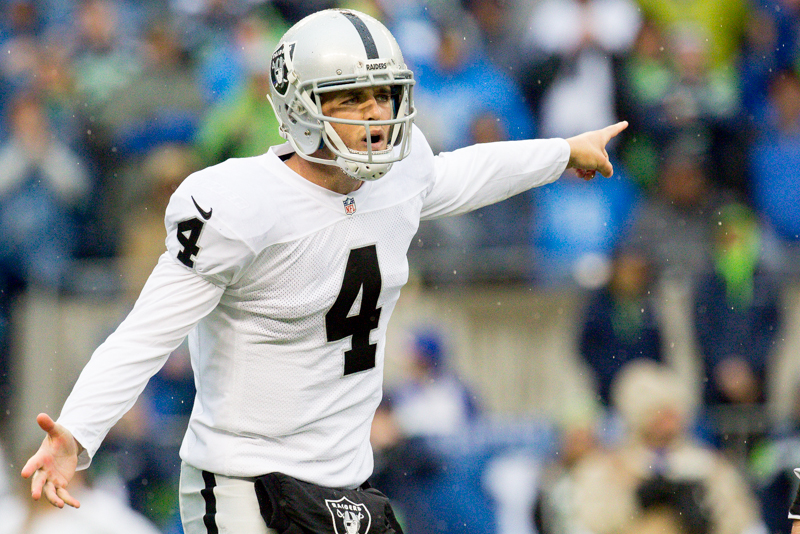 Raiders' quarterback Derek Carr gestures to the referees over a penalty in the third quarter.
