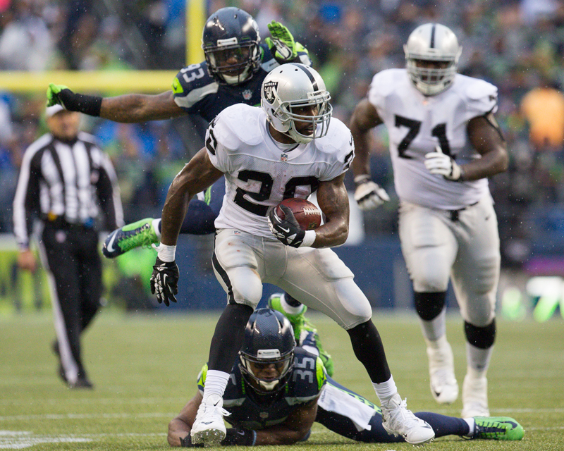 Raider running back Darren McFadden evades several Seattle defenders on a 23 yard run in the third quarter.