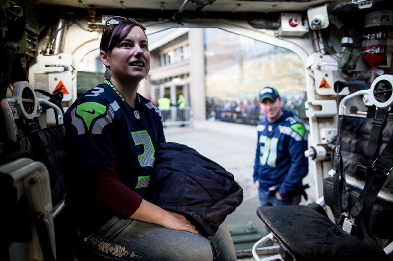 Rachel Willis, from Bozeman Montana, sits inside a Stryker vehicle from JBLM's 2-1 2nd brigade, on display before the Seahawks game.