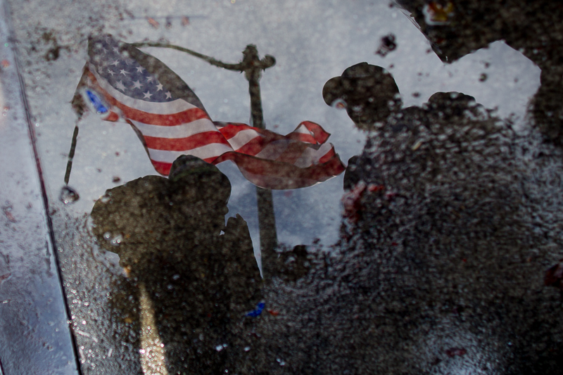 A US flag is seen waving in a puddle on the street before Sunday's Seahawks game.