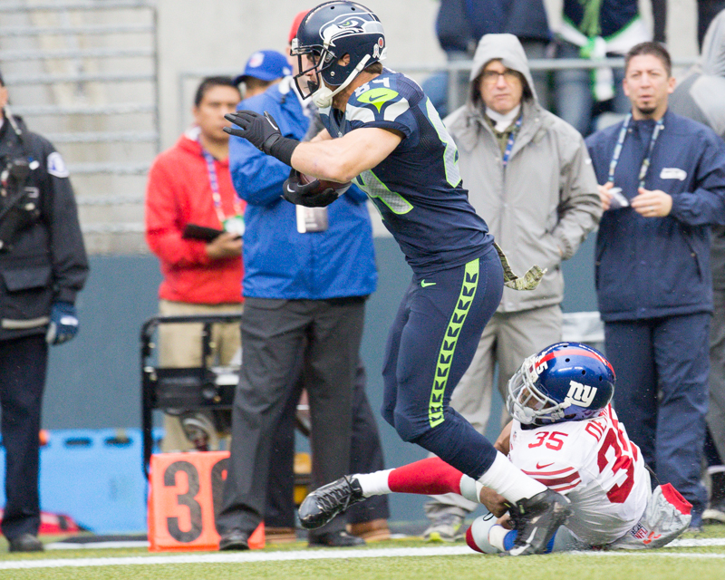 Seattle tight end Cooper Helfet is stopped up by a Giants defender after catching a 32-yard pass in the first quarter.