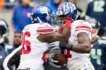 Giants cornerback Zach Bowman, right, is congratulated by teammates after intercepting a Russell Wilson pass in the first quarter.