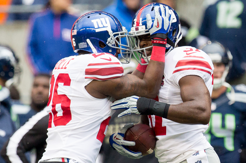 Giants cornerback Zach Bowman, right, is congratulated by teammates after intercepting a Russell Wilson pass in the first quarter.
