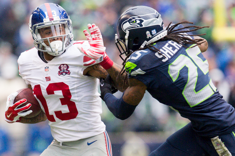 Giants receiver Odell Beckham fends off Seahawks cornerback Richard Sherman in the first quarter for a gain of six.