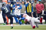 Seattle quaterback Russell Wilson is stopped up by a Giant's defender after an 8 yard run in the first quarter.