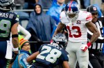 Giants receiver Odell Beckham shows his muscles to Seattle cornerback Marcus Burley after besting him to catch a 26-yard pass in the second quarter.
