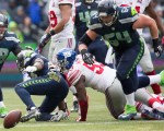 Players rush to grab hold of a fumbled ball by Seattle running back Robert Turbin in the second quarter. New York recovered the ball at the Seattle 47.