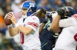 Eli Manning, quarterback for the Giants, scrambles out of a pinch in the fourth quarter.