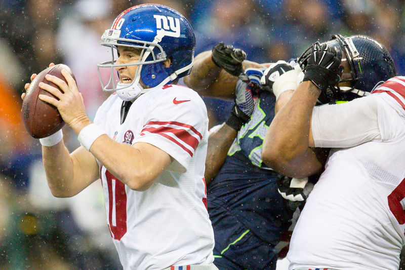 Eli Manning, quarterback for the Giants, scrambles out of a pinch in the fourth quarter.