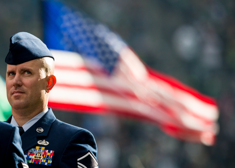 A service member steals a look at the big screen during pregame festivities.