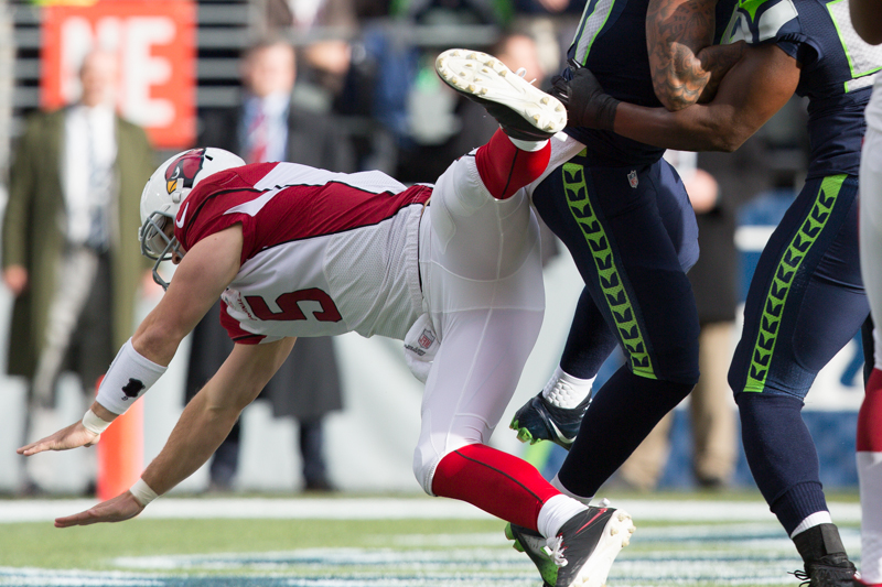 Cardinals quarterback Drew Stanton takes a hard fall after popping a short pass in the first quarter.