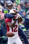Cardinals' receiver John Brown drops a pass broken up by Seattle's Byron Maxwell. Maxwell was called on the play for pass interference.