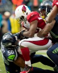 Cardinals' running back Stepfan Taylor is stopped up by Seattle's Kam Chancellor in the second half.