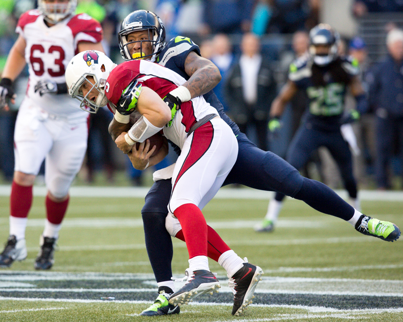 Arizona quarterback is taken down for a 3-yard loss by Bruce Irvin in the third quarter.