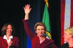 Maria Cantwell, Christine Gregoire and Patty Murray gather on the stage as Gregoire makes some comment about the close race.