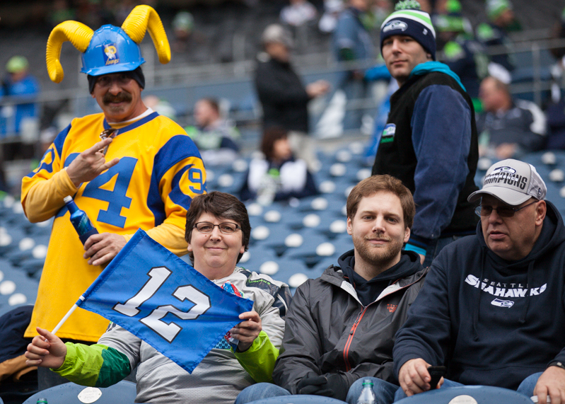 A Rams fan photobombs a group of 12th Man fans before the game.