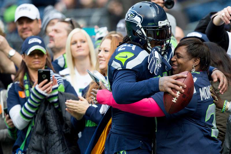 Seahawks' running back Marshawn Lynch gives his mother a hug before the team faces off against the St. Louis Rams.
