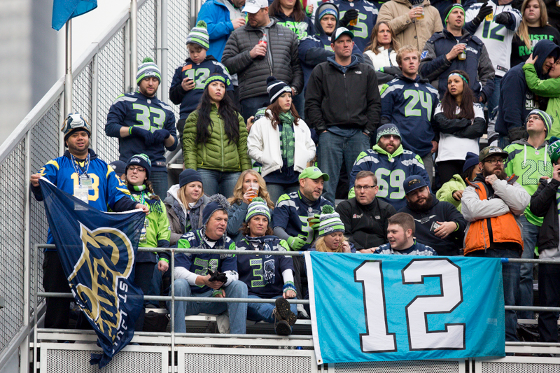 Flanked by a 12th man flag, a lone Rams fan supports his team in the Hawks Nest.