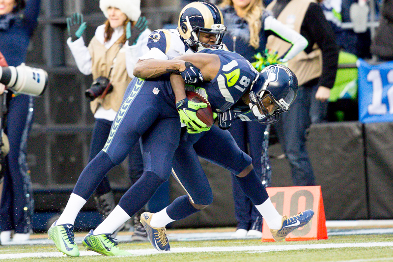 Hawks receiver Kevin Norwood drags a Rams defender downfield for a 31-yard pick up in the fourth quarter.