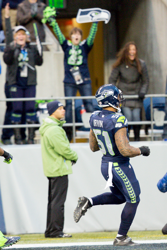 Seattle's Byran Irving reaches the end zone after intercepting a Rams pass in the fourth quarter.