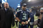 With NFC West division champ hat on, a victorious Russell Wilson exits the field after the game.