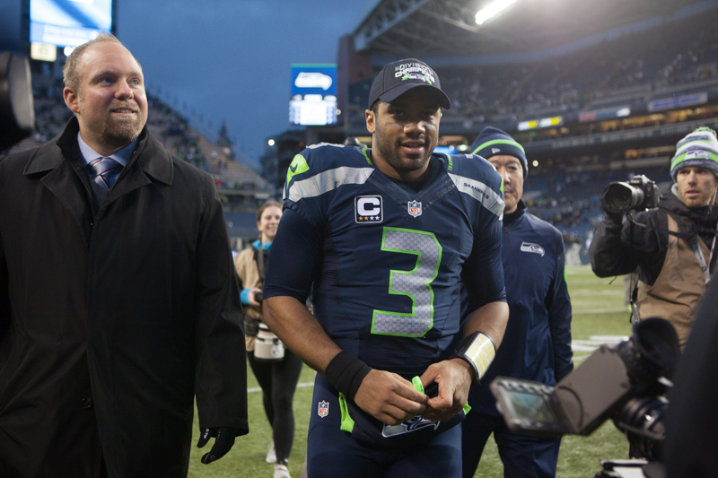 With NFC West division champ hat on, a victorious Russell Wilson exits the field after the game.