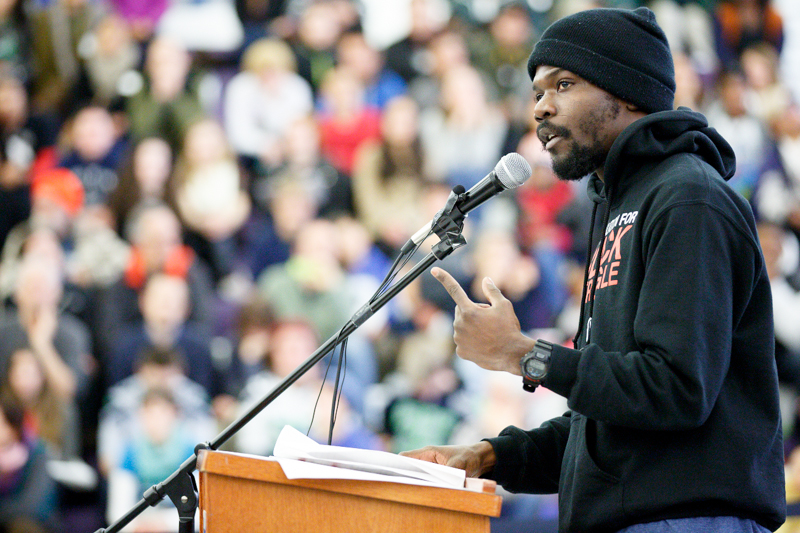 Activist and Ferguson-based organizer Jelani Brown speaks to the crowd at Garfield High School before the march.