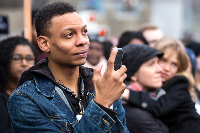 Members of the crowd listen to pre-march speakers outside Garfield High.