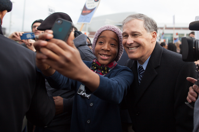 A girl takes a selfie with Governor Jay Inslee at a pre-march rally.