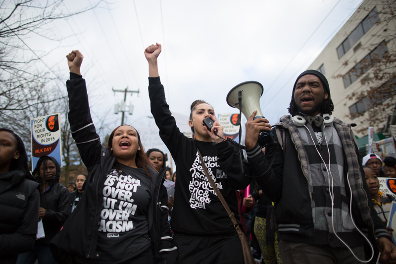 Marchers cry out "Same story every time: being black is not a crime!" while taking part in an MLK Day march in Seattle.