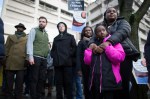 Marchers listen to speakers in front of the King County Detention Center.