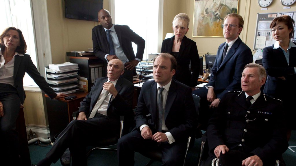 Rory Kinnear (center) as the aghast PM receiving his ransom demand in “The National Anthem.”