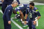 Seahawks head coach Pete Carroll talks with Russell Wilson.