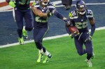 Jeremy Lane runs upfield after intercepting a pass by Tom Brady.