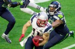 Julian Edelman evades Seattle defenders in the first half.