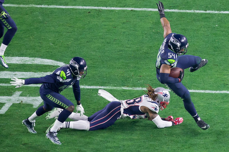 Seattle linebacaker Bobby Wagner intercepts Tom Brady in the first half.