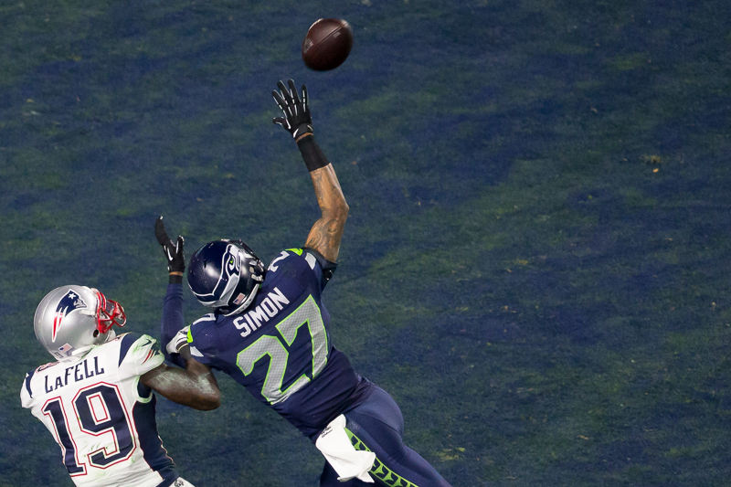Players from each team fight for a deep endzone pass in the second quarter. The play was ruled incomplete.