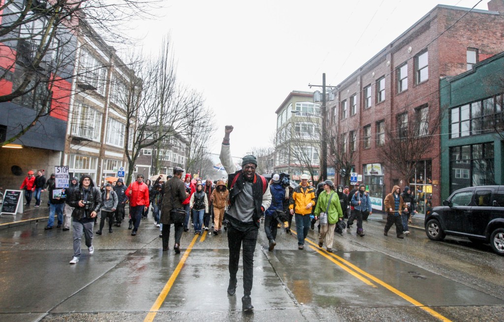 Matthew Wyatt leads protesters along East Pike Street, chanting "Black Lives Matter." Hundreds marched Capitol Hill for the Walking While Black: Always Dangerous Until Proven Otherwise protest on Saturday, Feb. 7, 2015.