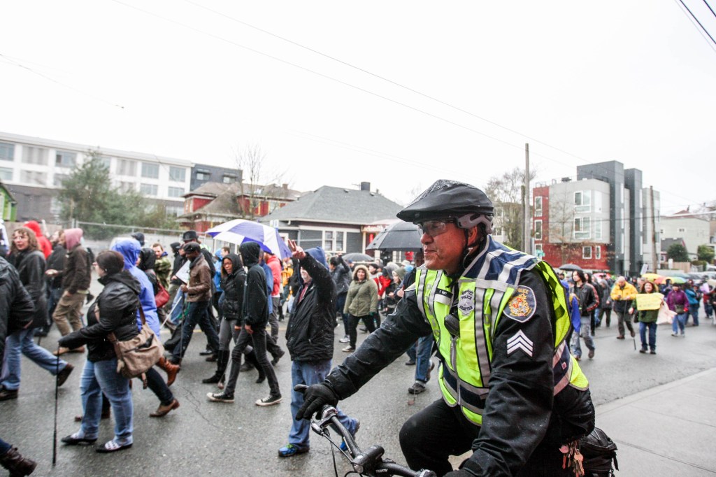 SPD Sergeant Fred Ibuki rides along the route of the protest, making sure it stays peaceful. Many marched through Capitol Hill protesting racial profiling of the Seattle Police.