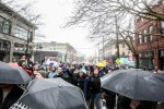 Hundreds of protesters hold up golf clubs while marching along the streets of Capitol Hill, Saturday afternoon. Golf clubs were brought in solidarity with William Wingate, a 70 year old black man who was arrested on July 9, 2014 for "walking in Seattle while black."