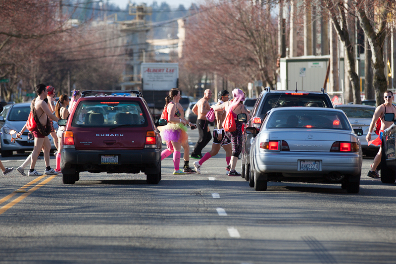Runners cross North 36th Street, much to the surprise of drivers.