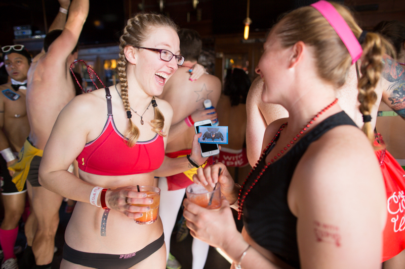A runner shows her friend a Batman-themed Valentine given to her by another runner.