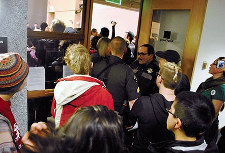 Police guard the entrance to the King County Council chambers during the February 9 hearing. Photo by Celia Berk