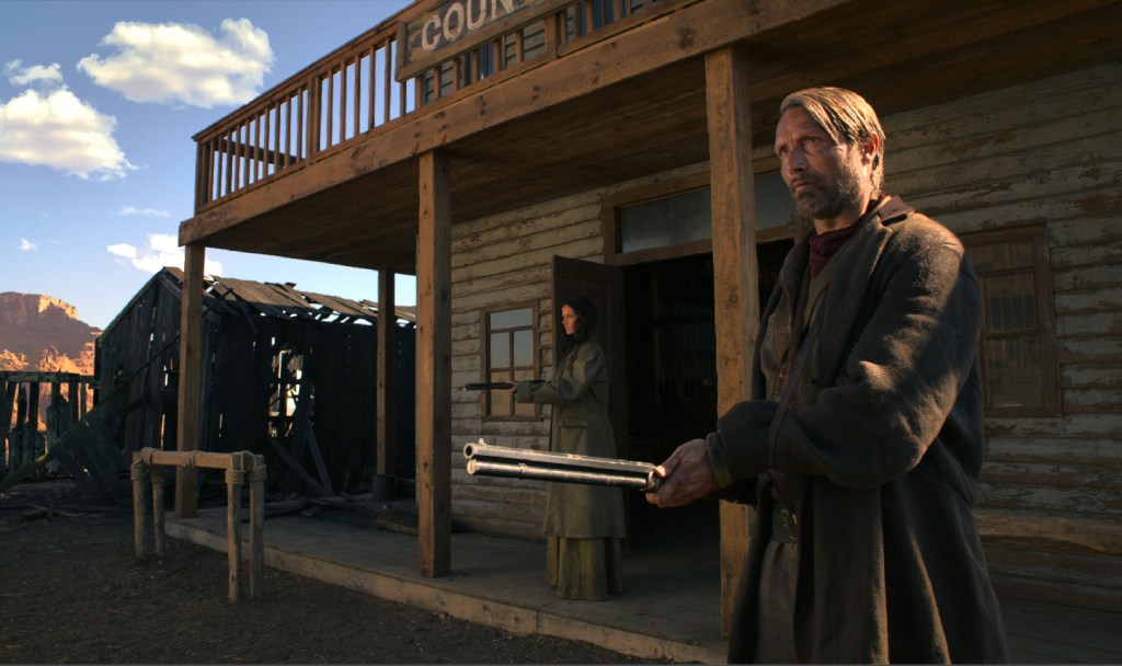 Mikkelsen as gunslinger, with Green to rear.