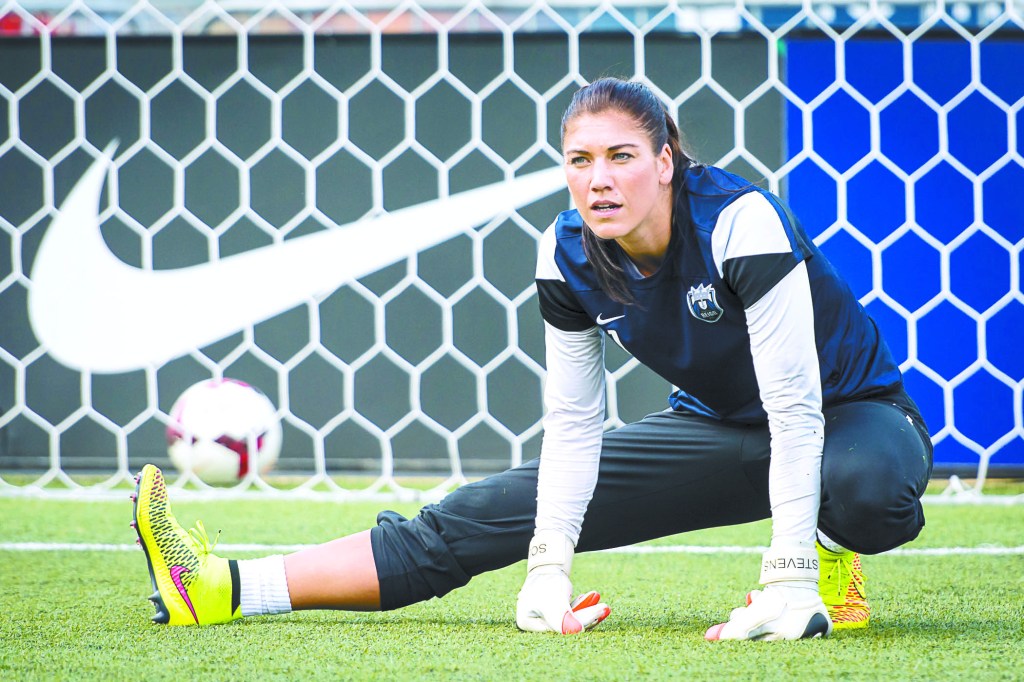 Solo stretches prior to a Reign FC match, Stevens with her in spirit.