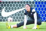 Solo stretches prior to a Reign FC match, Stevens with her in spirit.