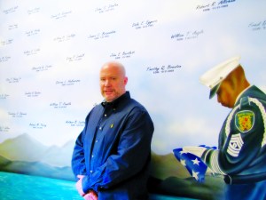 Smith stands before a memorial for fallen officers at the Seattle Police Officers Guild offices.