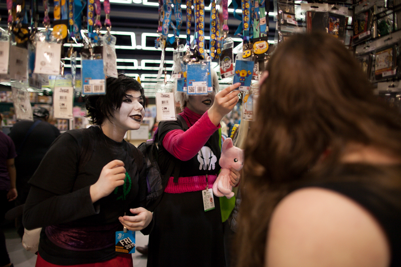 Participants look through collectible lanyards at the show.